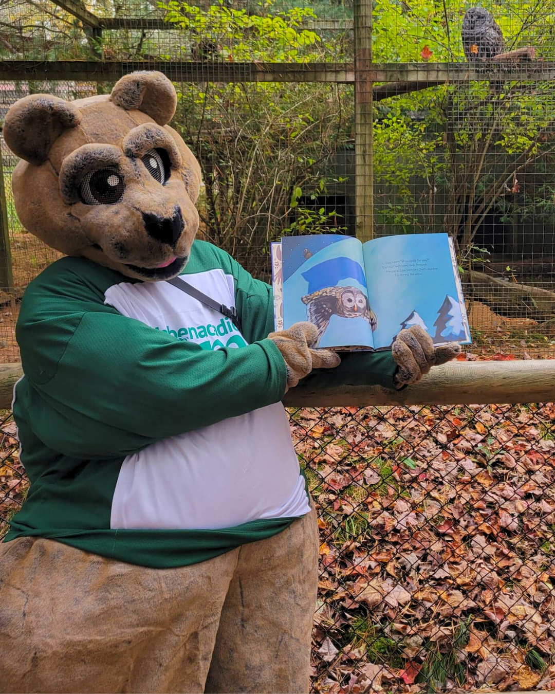 Shubenacadie Sam Mascot holding his book open